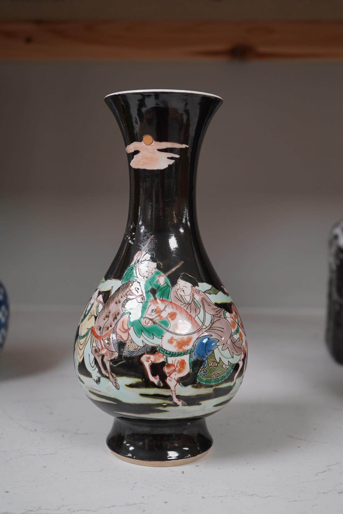 Two Chinese vases; a blue and white double gourd vase and famille noir vase, famille noir 19cm high. Condition - good